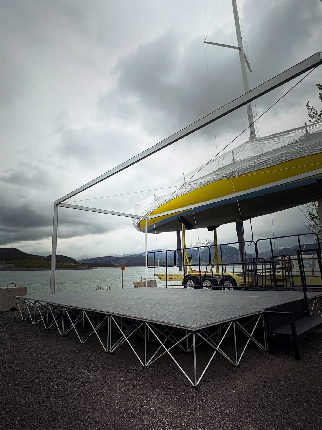 The new live-music stage set on the deck, lake and mountains behind it.